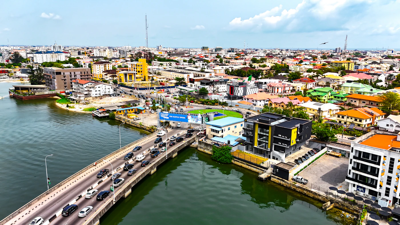 An aerial view of a bridge and waterfront neighbourhoods in Lagos
